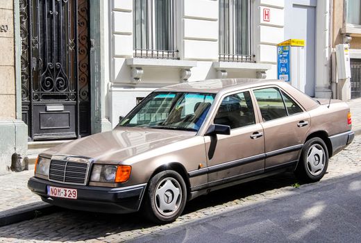 BRUSSELS, BELGIUM - AUGUST 9, 2014: Motor car Mercedes-Benz W124 E-class at the city street.