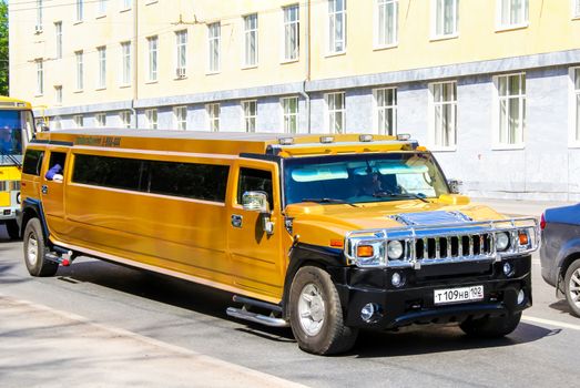 UFA, RUSSIA - MAY 25, 2012: Golden limousine Hummer H2  at the city street.