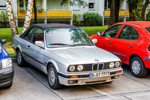 BERLIN, GERMANY - JULY 20, 2014: Motor car BMW E30 3-series at the city street.