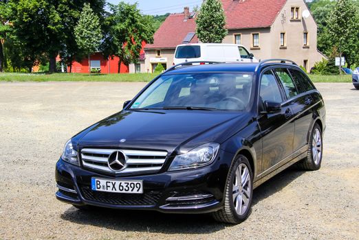 KOENIGSBRUECK, GERMANY - JULY 20, 2014: Motor car Mercedes-Benz W204 C180 at the town street.