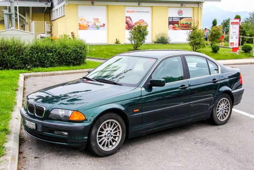 MONTREUX, SWITZERLAND - AUGUST 6, 2014: Motor car BMW E46 3-series at the parking near the intercity freeway.