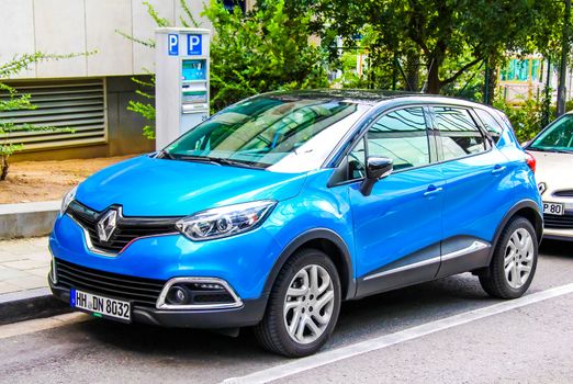 BRUSSELS, BELGIUM - AUGUST 9, 2014: Motor car Renault Captur at the city street.