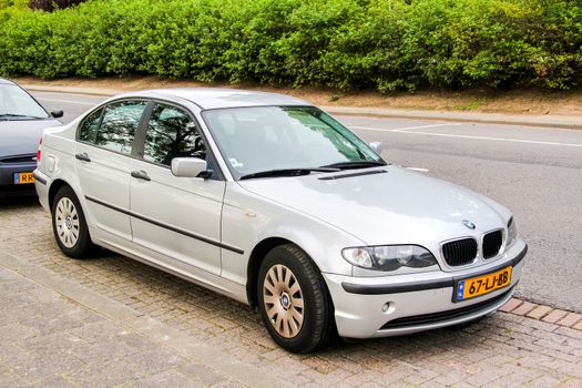 ROTTERDAM, NETHERLANDS - AUGUST 9, 2014: Motor car BMW E46 3-series at the city street.