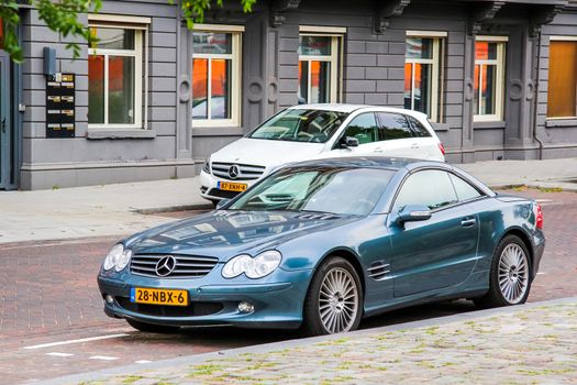 ROTTERDAM, NETHERLANDS - AUGUST 9, 2014: Motor car Mercedes-Benz R230 SL-class at the city street.