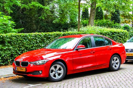 ROTTERDAM, NETHERLANDS - AUGUST 9, 2014: Motor car BMW F30 3-series at the city street.