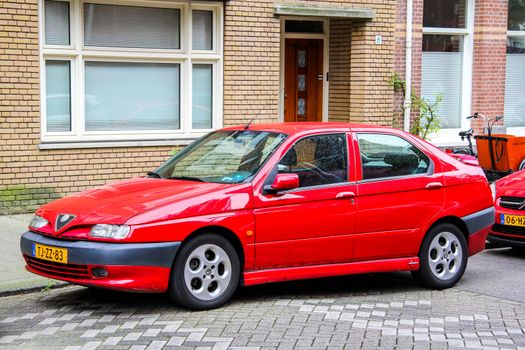 AMSTERDAM, NETHERLANDS - AUGUST 10, 2014: Motor car Alfa Romeo 146 at the city street.