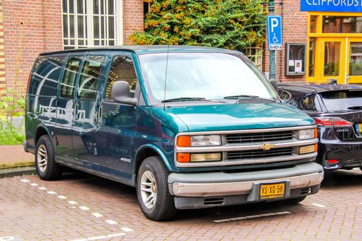 AMSTERDAM, NETHERLANDS - AUGUST 10, 2014: Motor car Chevrolet Express at the city street.