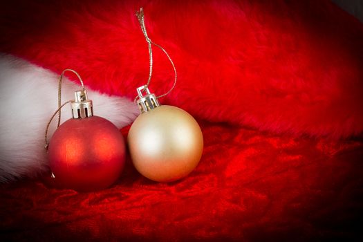 gold and red ball on Santa Claus hat  with dark vignette