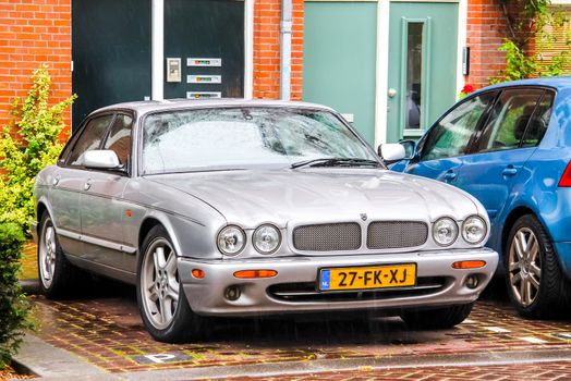 AMSTERDAM, NETHERLANDS - AUGUST 10, 2014: Motor car Jaguar XJ at the city street.