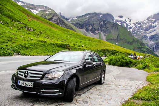 TYROL, AUSTRIA - JULY 29, 2014: Black estate car Mercedes-Benz W204 C180 at the Grossglockner High Alpine road.