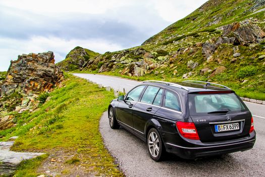 TYROL, AUSTRIA - JULY 29, 2014: Black estate car Mercedes-Benz W204 C180 at the Grossglockner High Alpine road.