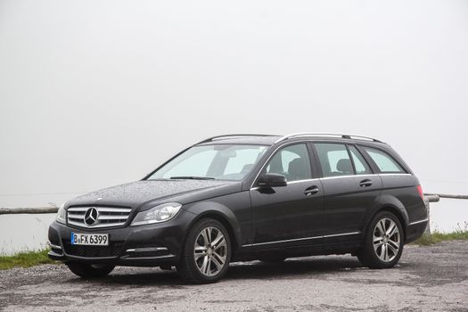 TYROL, AUSTRIA - JULY 29, 2014: Black estate car Mercedes-Benz W204 C180 at the Grossglockner High Alpine road.