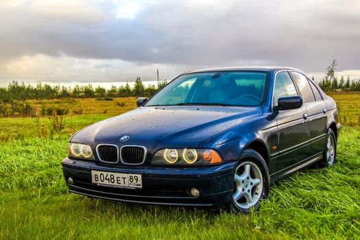 NOVYY URENGOY, RUSSIA - AUGUST 21, 2015: Motor car BMW E39 520i at the countryside.