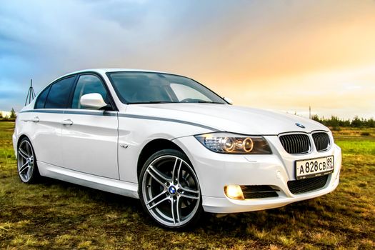 NOVYY URENGOY, RUSSIA - AUGUST 21, 2015: Motor car BMW E90 318i at the countryside.