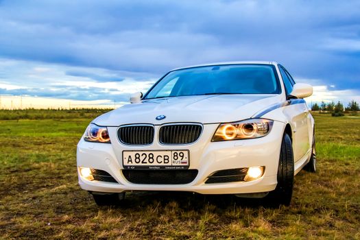 NOVYY URENGOY, RUSSIA - AUGUST 21, 2015: Motor car BMW E90 318i at the countryside.