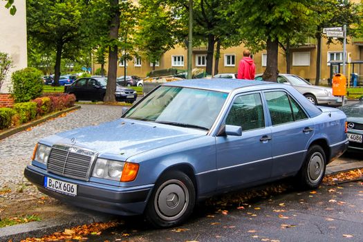 BERLIN, GERMANY - SEPTEMBER 10, 2013: Motor car Mercedes-Benz W124 E-class at the city street.