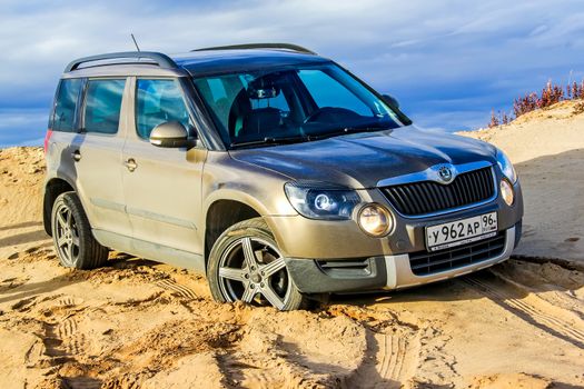 NOVYY URENGOY, RUSSIA - SEPTEMBER 5, 2015: Motor car Skoda Yeti at the sand desert.