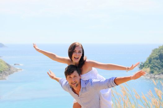 Cheerful couple having fun on vacation at seaside