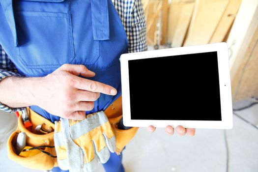 Construction worker pointing at digital tablet close-up