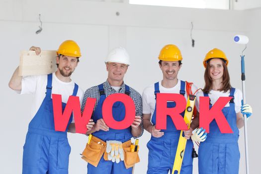 Team of happy workers with work letters and tools