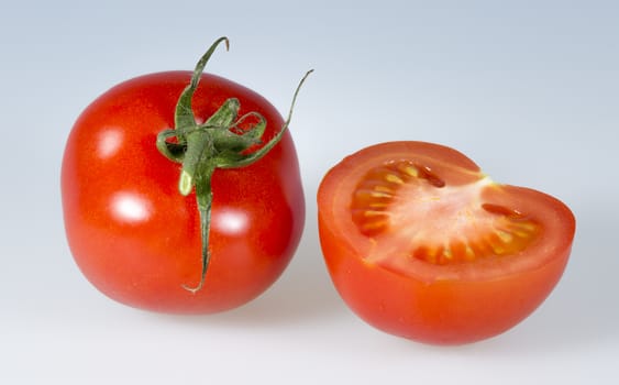 Tomatoes Close Up. One whole and one cut.