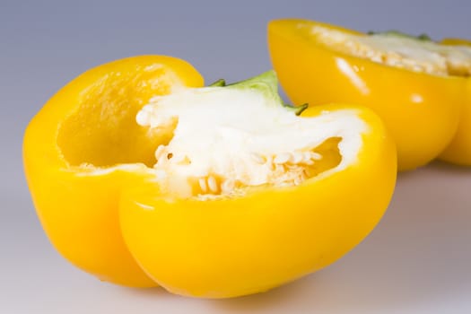 Sliced Yellow Bell Pepper close up on grey background.
