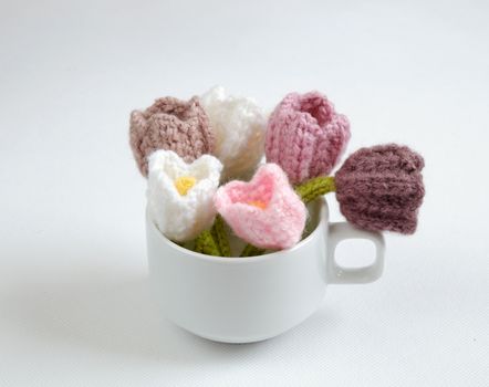 Spring flower for springtime, colorful handmade tulip on white background, diy product by knit can make gift for woman day or mother day