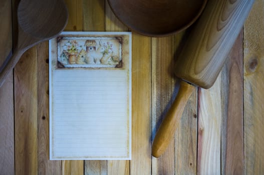 Kitchen scene with blank recipe card, wooden spoon, bowl, and rolling pin, on rustic wood plank background







Kitchen scene with  blank recipe
