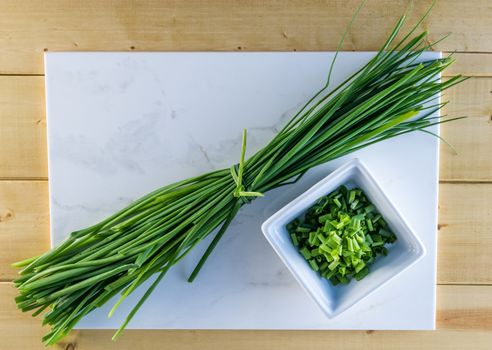 Fresh chives on white marble