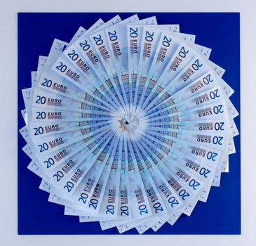 Circular fan of Euros (20's) on vibrant blue background
