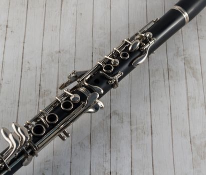 Black clarinet closeup on whitewashed wood background