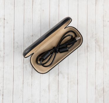 Eyeglass case repurposed for travel cord caddy, a popular "travel hack"