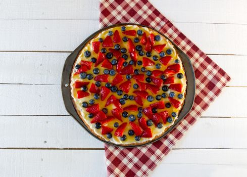 Fresh fruit pizza on red plaid cloth