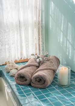 Luxury master bath escape scene with spa towels and candle
