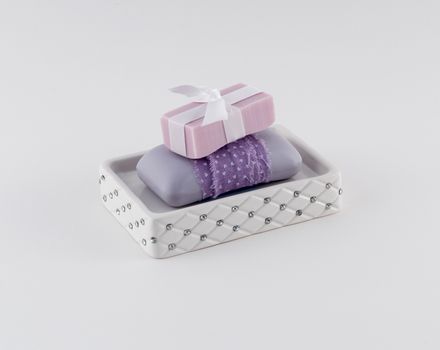 Luxury soap in soap dish, on white background