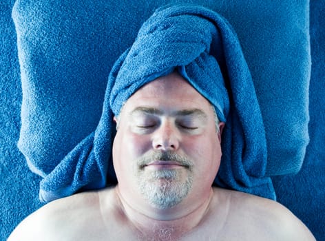 Man in blue turban towel resting at the spa