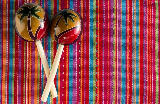 Pair of maracas on colorful background