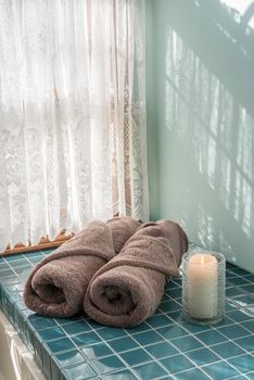Master bathroom luxury towels and lit candle