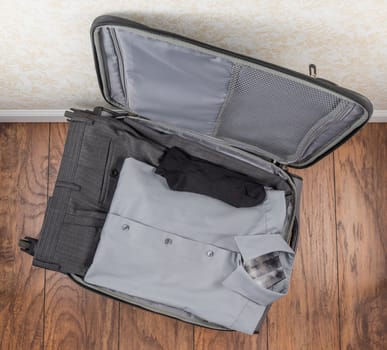 Packed carry-on suitcase with men's clothing