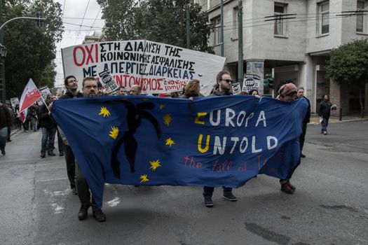 GREECE, Athens: People hold signs as thousands take to the streets of Greece's capital city to fight against planned cuts in future benefits and increased social security contribution on January 16, 2016.  Saturday's protests in Omonia Square involves civil servants who are members of ADEDY. The unions said they are against plans for employees's social security contributions to be increased by 0.5 percent. 