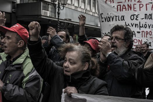 GREECE, Athens: People cheer as thousands take to the streets of Greece's capital city to fight against planned cuts in future benefits and increased social security contribution on January 16, 2016.  Saturday's protests in Omonia Square involves civil servants who are members of ADEDY. The unions said they are against plans for employees's social security contributions to be increased by 0.5 percent. 
