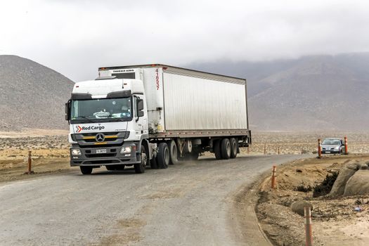ATACAMA, CHILE - NOVEMBER 14, 2015: Semi-trailer truck Mercedes-Benz Actros at the gravel interurban freeway through the Atacama desert.
