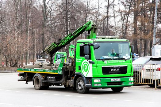 MOSCOW, RUSSIA - MARCH 8, 2015: Green rescue service truck MAN TGL in the city street.