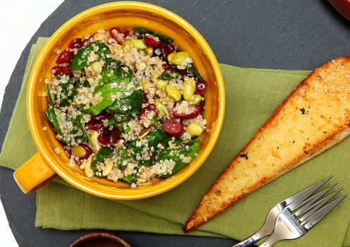 Quinoa Spinach Cranberry Salad and Garlic Toast on Table. Above top view.