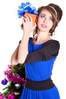 Portrait of a beautiful young woman holding a present isolated over white background