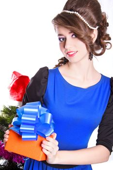 Portrait of a beautiful young woman holding a present isolated over white background