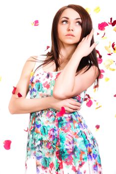 Beautiful young woman in a bright many-colored dress isolated over white background