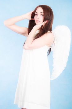 Beautiful young angel over cyan background