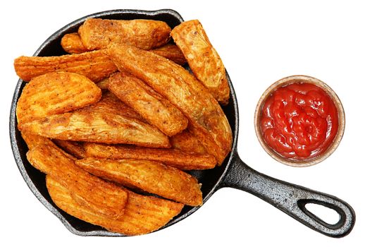 Baked Seasoned Potato Wedges in Cast Iron Skillet With Ketchup Isolated over white.