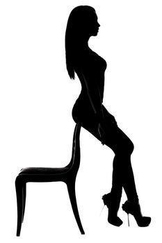 Silhouette of a woman sitting on the back of the chair